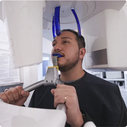 Image with a professional dentist attending to a patient.