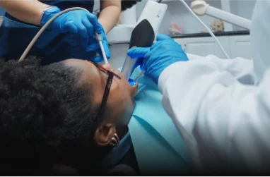 Patient receiving emergency dental treatment in a modern, well-equipped dental clinic